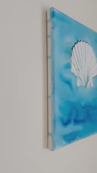 Watercolor seashell painted on canvas with layered ocean blues, coastal art by Ashley Lucas